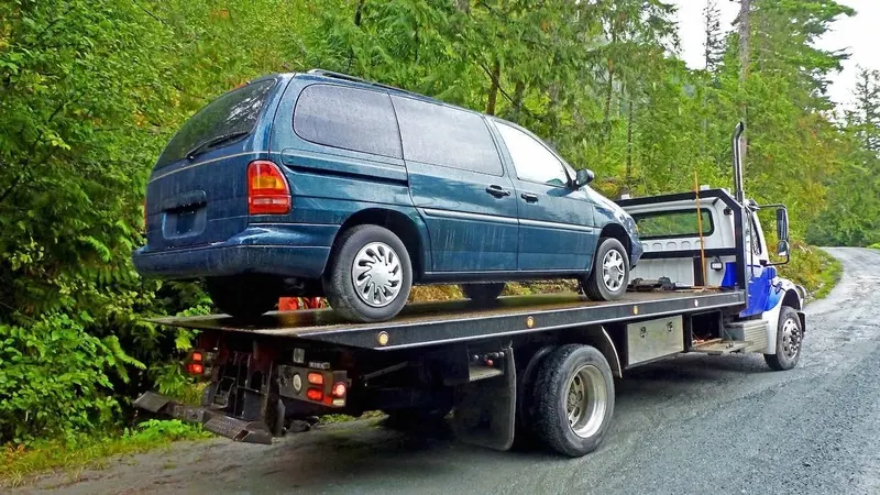 Laval flatbed towing a cargo van