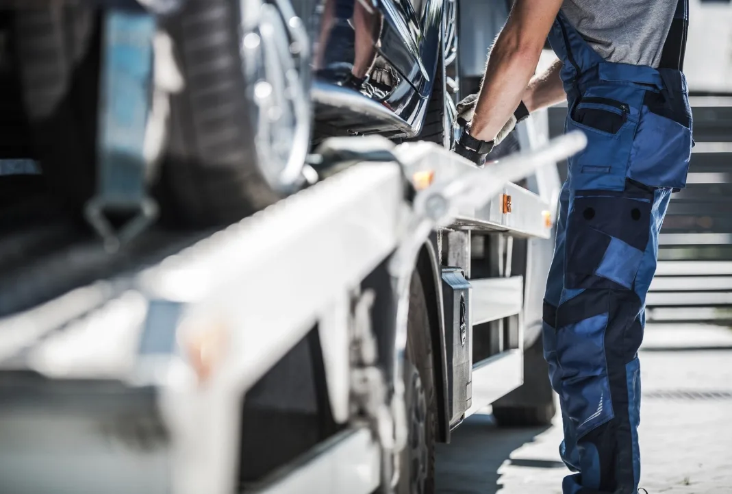 Laval tow truck driver loading a car onto a flatbed