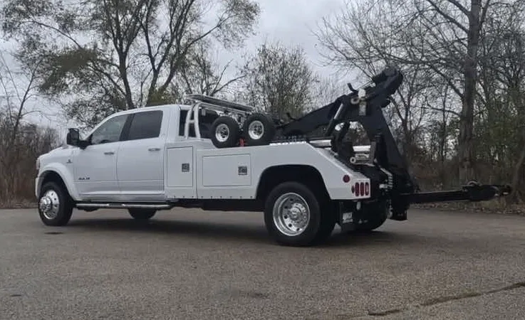 Laval wrecker equipment securing damaged vehicle